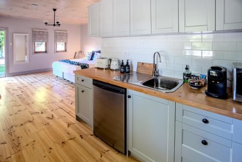 a kitchen with a sink and a counter top at Willunga Gallery Cabins in Willunga