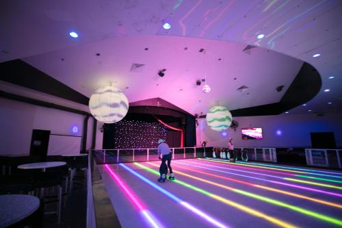 a man is walking down a bowling alley at Paradise Resort Gold Coast in Gold Coast