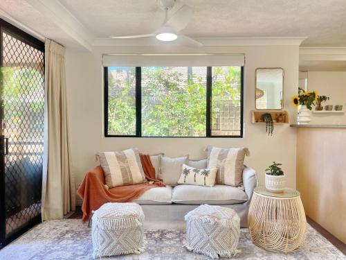 a living room with a couch and a window at Mermaid Beach Park View in Gold Coast