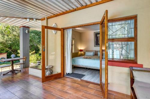 a bedroom with a bed and a window at Villa Helderberg in Somerset West