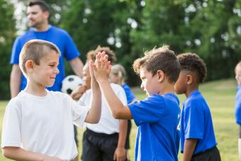 kids showing good sportsmanship at soccer camp