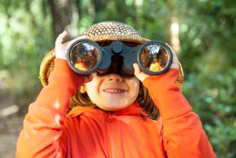 Young girl looking through binoculars