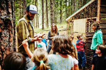 Counselors giving instructions to kids at camp