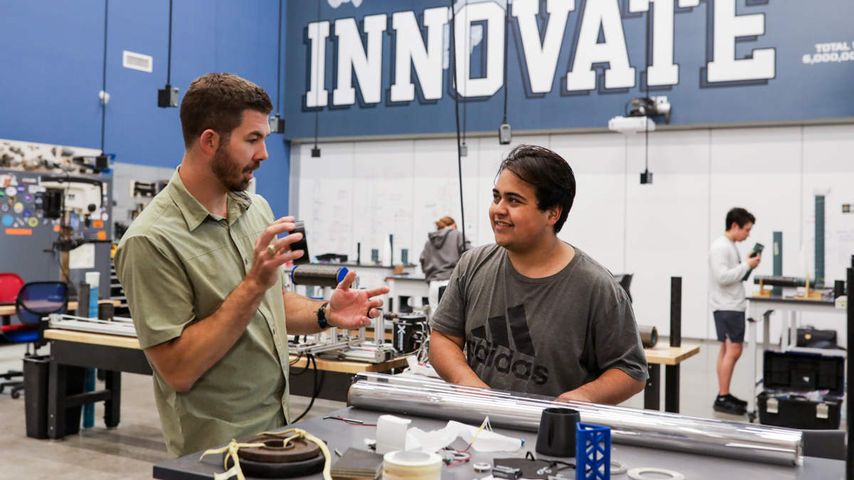 Rocket teacher Chris McLeod works with a student in the rocketry lab at Brazoswood High School