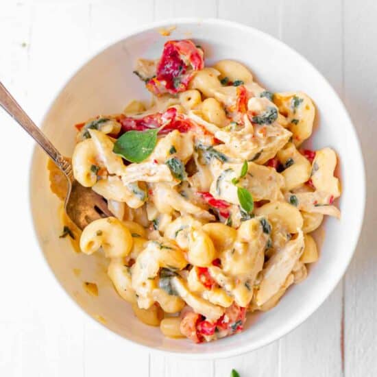 tuscan chicken mac and cheese in a bowl.