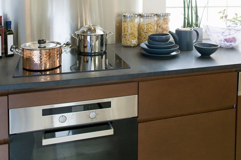 Induction hob on kitchen countertop with oven underneath