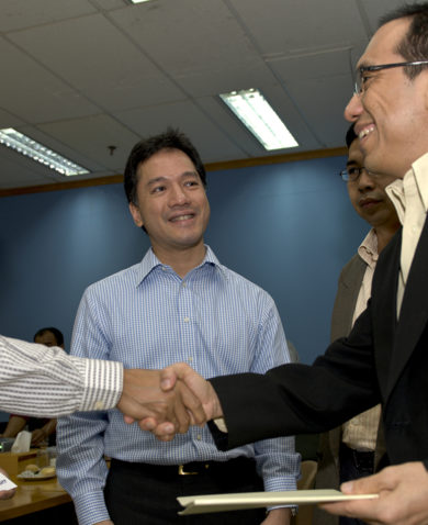 Men shaking hands and smiling