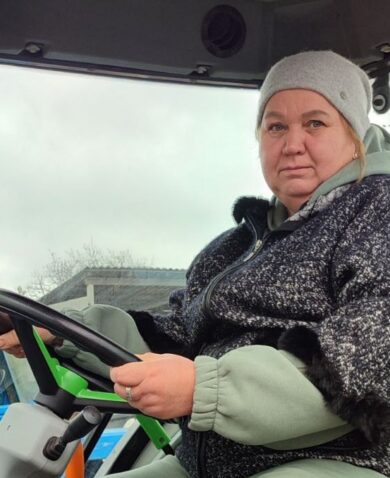 A woman sits in a tractor