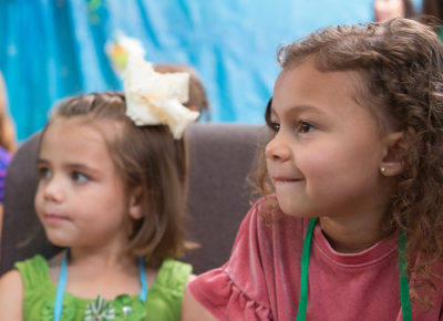 A preschool girl listens during a lesson on Zacchaeus.