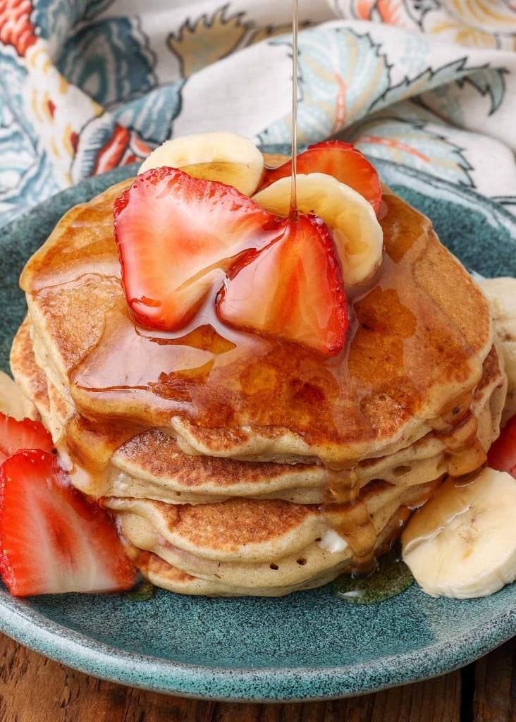 maple syrup pour shot over Pancakes with Strawberries 