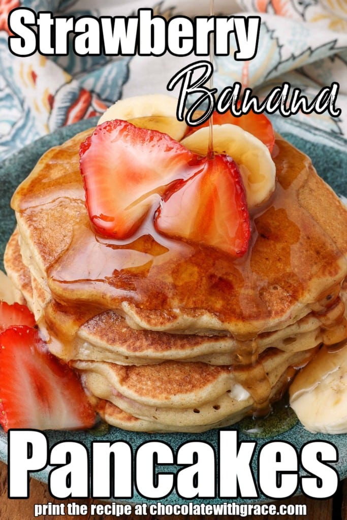 close up shot of strawberry pancakes with bananas and maple syrup