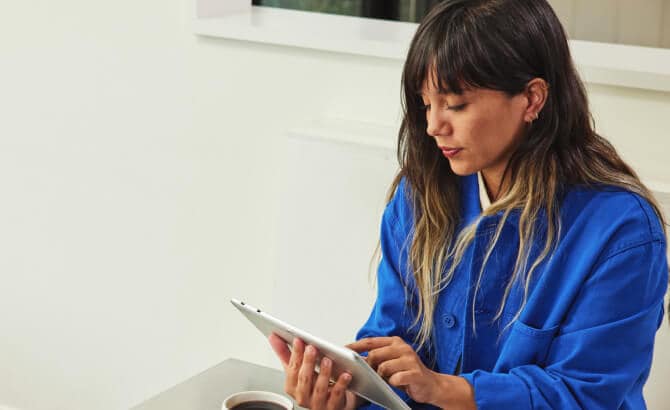 Mujer joven con una tablet en mesa