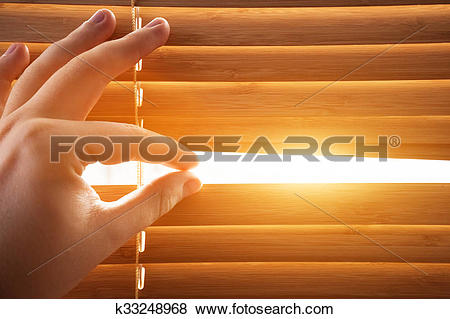 Pictures of Looking through window blinds, sun light coming inside.