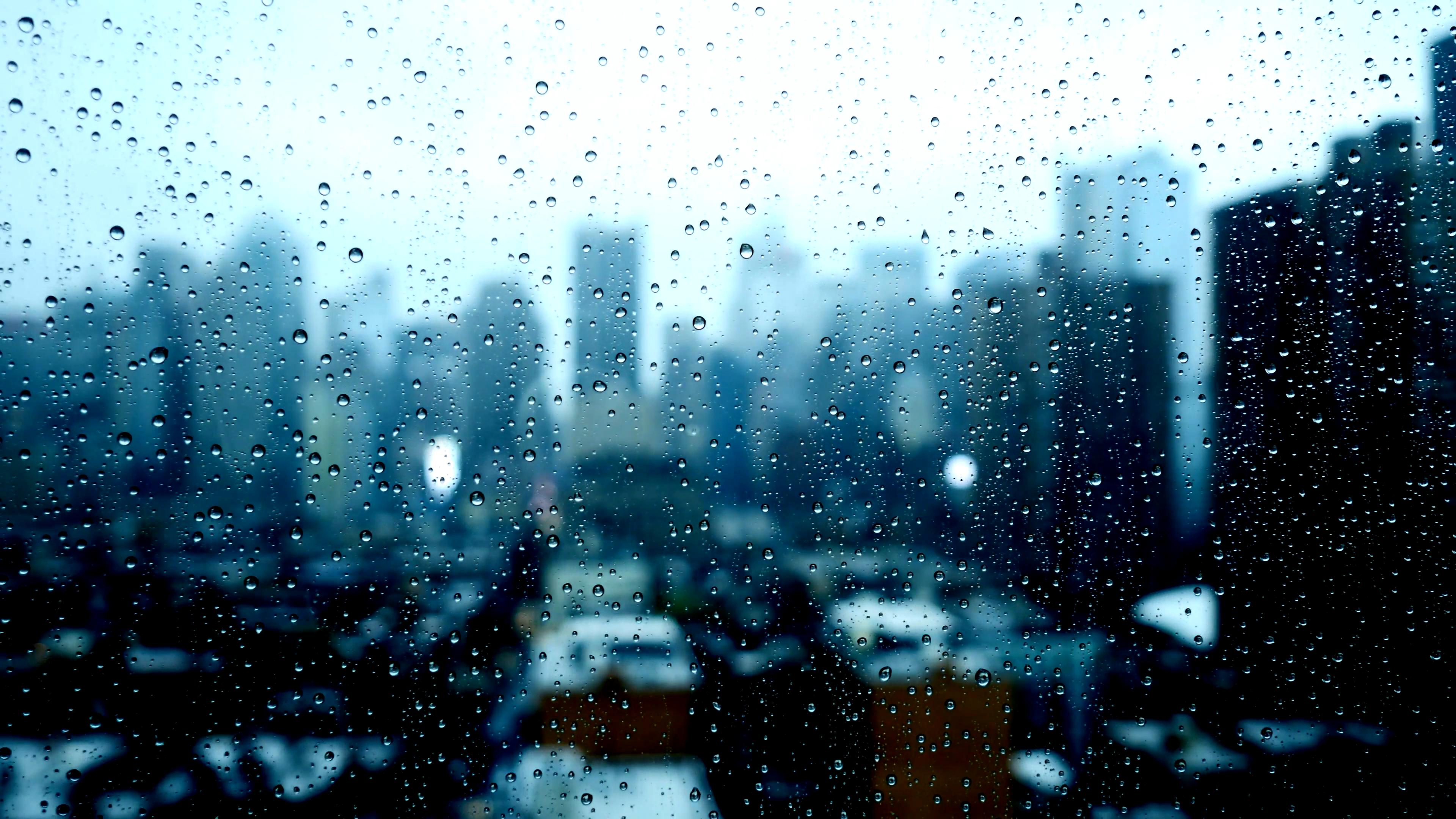 blurry city skyline window view. sad bad weather. rain drops background.