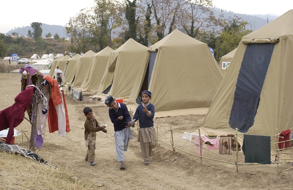 Free photo Tents Children Trees Pakistan Shinkiari Camp.