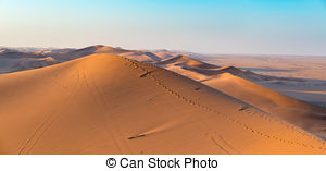 Stock Photo of Tourist walking in the majestic Namib desert.