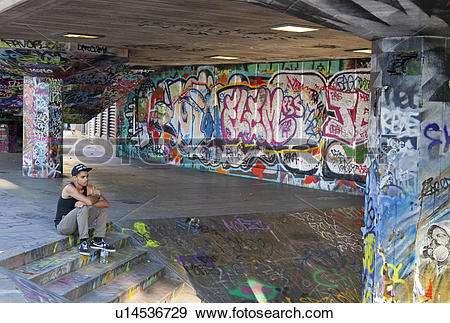 Stock Photograph of England, London, South Bank. Resting cyclist.