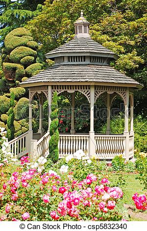 Stock Photography of Wooden gazebo in rose garden in spring.