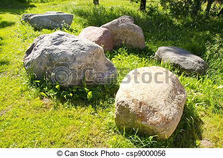 Stock Image of Large stones garden verdant meadow rural scenery.