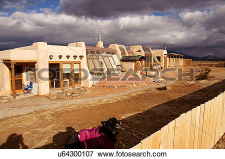 Picture of earthship adobe home house dog taos new mexico.