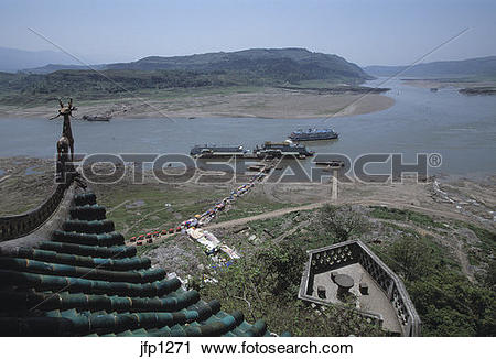 Stock Photography of Tourists crowd a muddy path after departing.