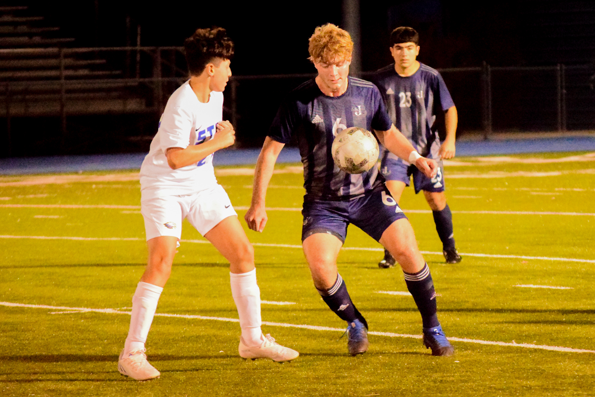 St. Joseph by-the-Sea's Jonathan Williams, in blue, gains control of the ball as St. Peter's Lee D'Esposito closes in. (Staten Island Advance/Annie DeBiase)