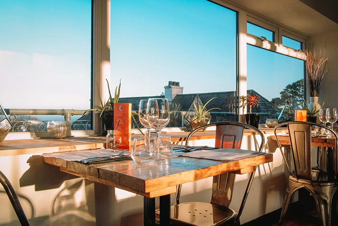 One of the welcoming tables at Radius 7 overlooking the sea, one of the best fish and chips in Devon