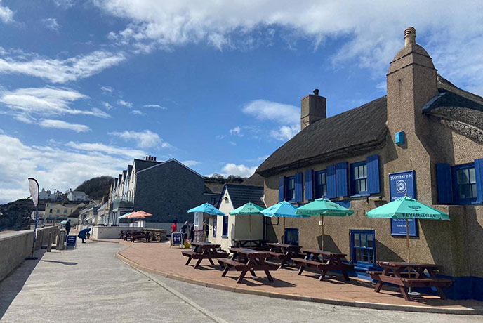 The traditional thatched exterior of Start Bay Inn, one of the best fish and chips in Devon