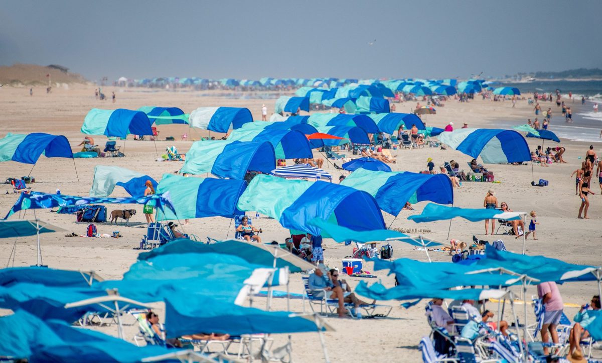 A sea of sunshades hug the shoreline recently in Atlantic Beach on Bogue Banks. Photo: Dylan Ray