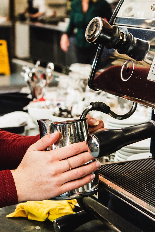 Steaming milk for a latte in Europe