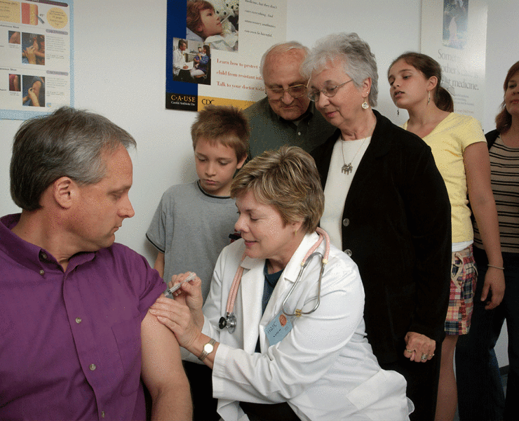 Unsplash photo from the CDC illustrating vaccine administration by a doctor in a white lab coat