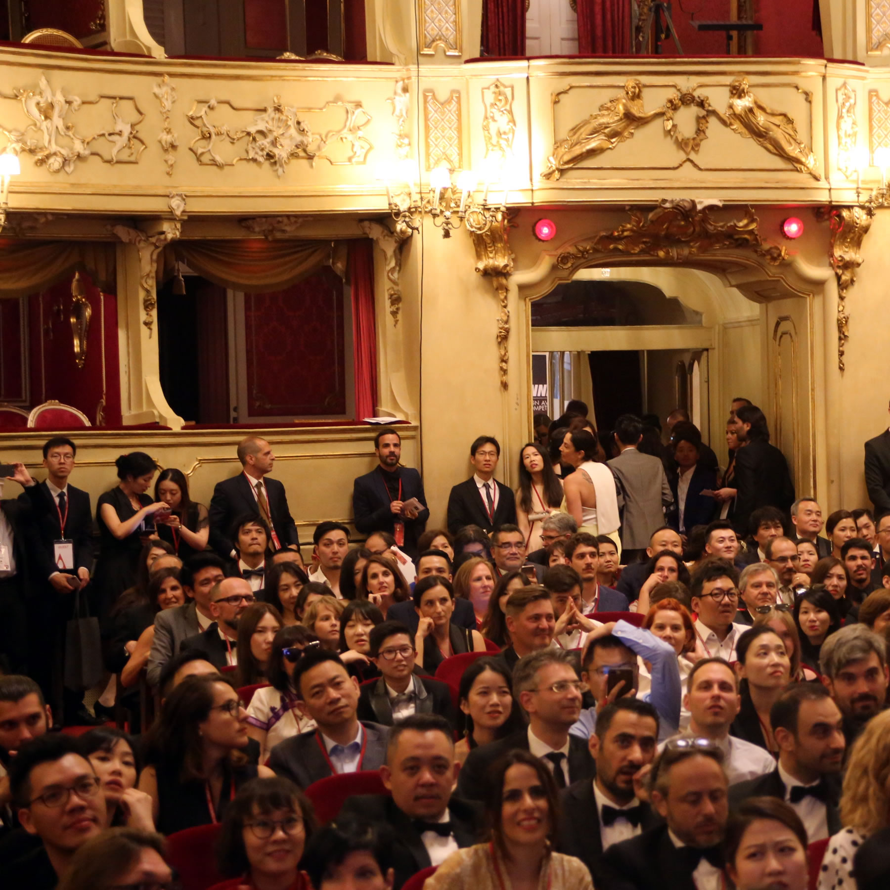 Photograph of gala-night guests eagerly waiting for ceremony to begin