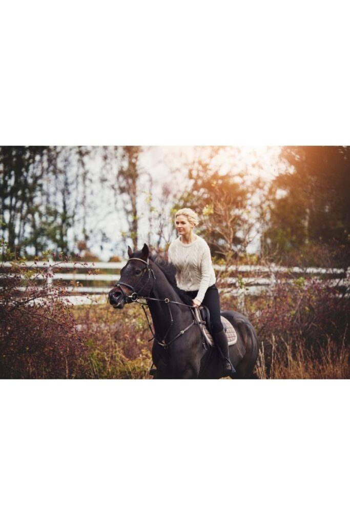 image of a woman riding a horse.