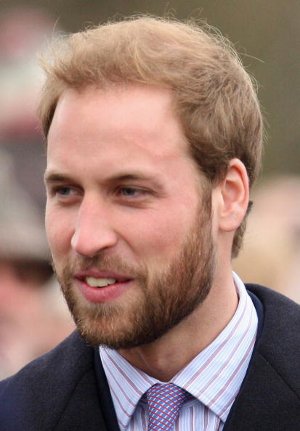 A man with shaggy layers cut smiling.