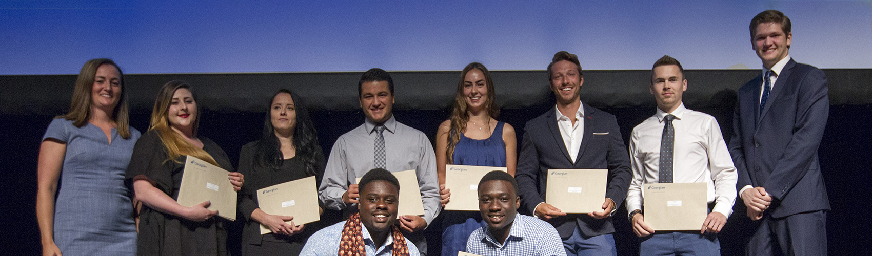 Group of student award and scholarship recipients on stage to receive their awards.