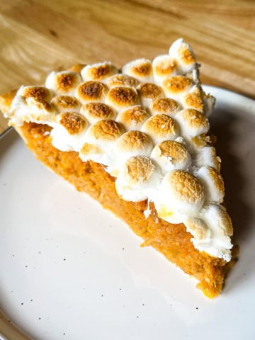 Slice of sweet potato casserole pie on a plate.