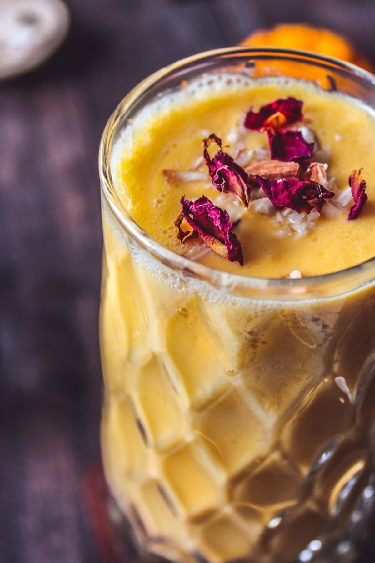 Glass of lassi on wood table