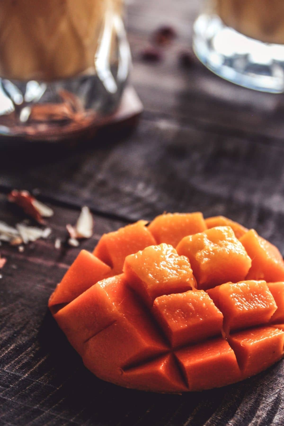 Mango half sliced on table