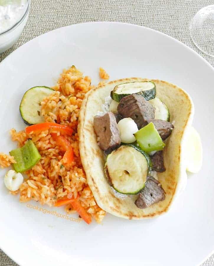 Greek marinated Lamb and Vegetable Kabobs, grilled to perfection with green peppers, zucchini, and pearl onions...served in heated pita with Tzatziki! cookingwithcurls.com