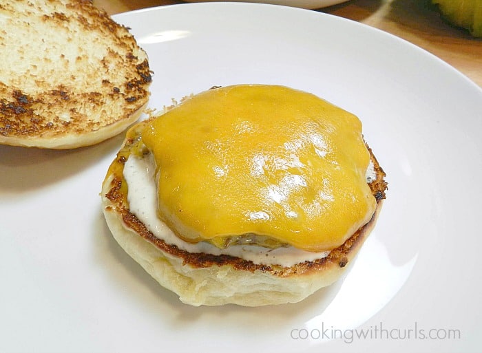 Melted cheese-topped burger on a bun.