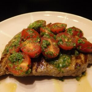 Steak with salsa verde and tomatoes