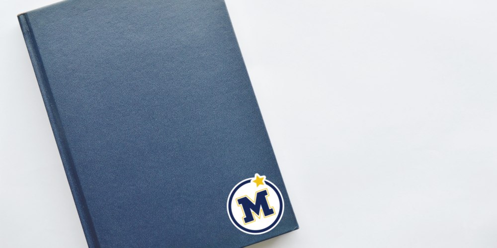 a blue book with a Mahtomedi logo