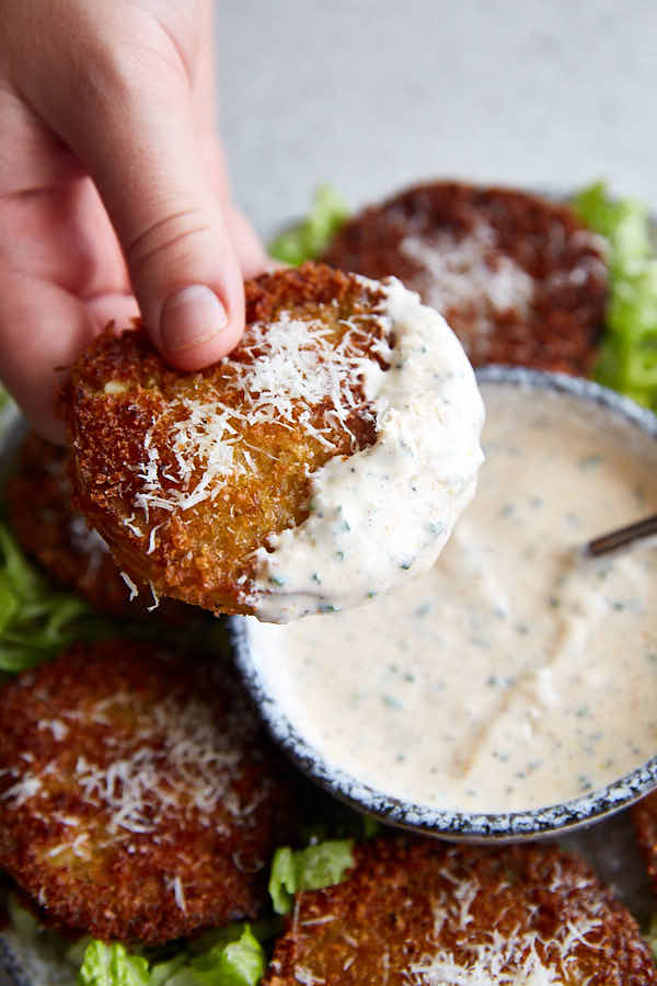 Fried Green Tomatoes dipped in white dipping sauce