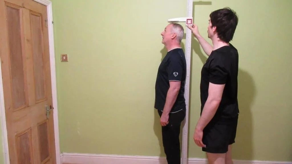 A man getting his height measured