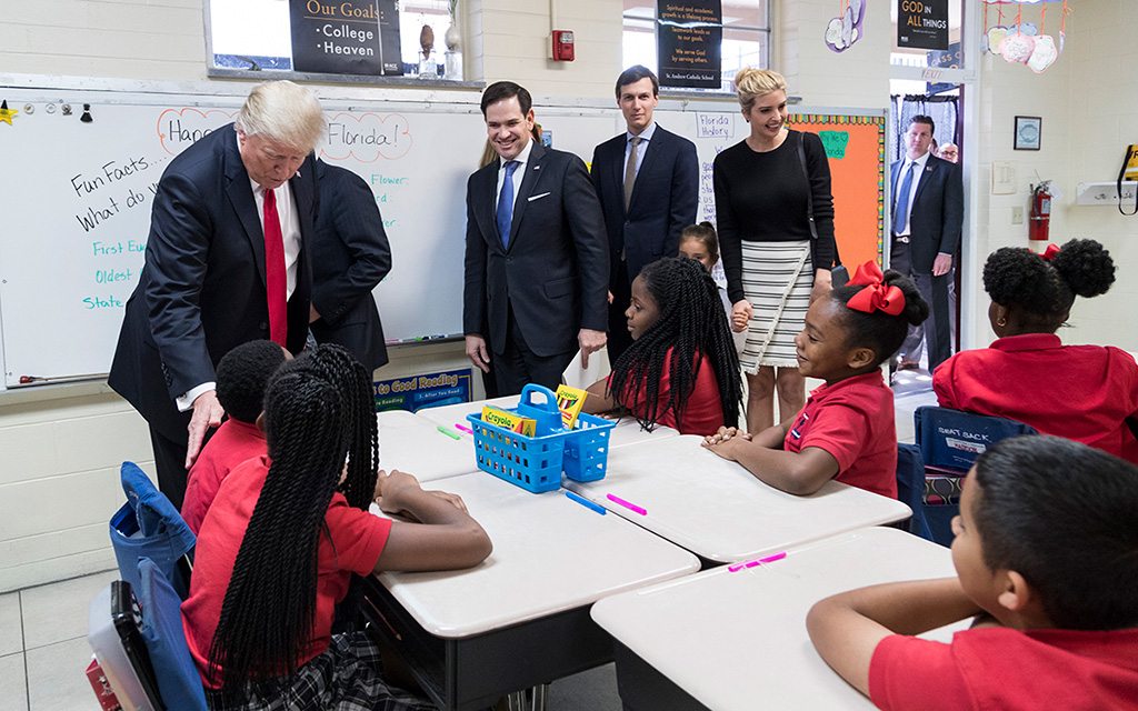 President Donald Trump visits a fourth grade classroom at Saint Andrew Catholic School in Orlando, Florida, Friday, March 3, 2017.