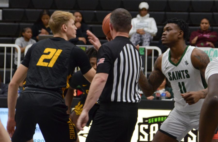 Forward Mario Whitley, a sophomore from Detroit, Michigan, gets ready to go up for the jump ball. Whitley gained 13 rebounds last night making his overall rebounds 126.