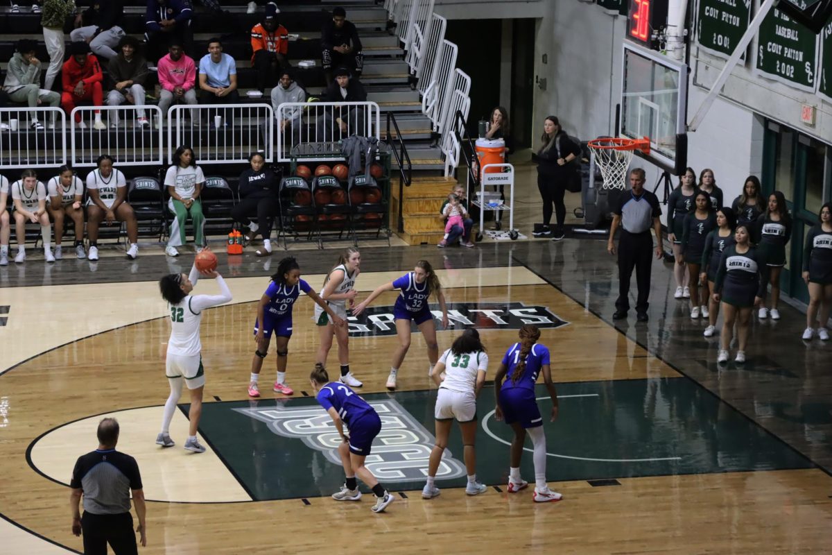 Sophomore forward Allie Myers draws a foul and scores a free throw for the Lady Saints. She maintained her aggressive play style, supporting the team’s offensive momentum.