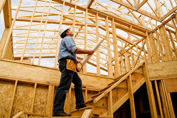 a custom home builder reviewing construction plans