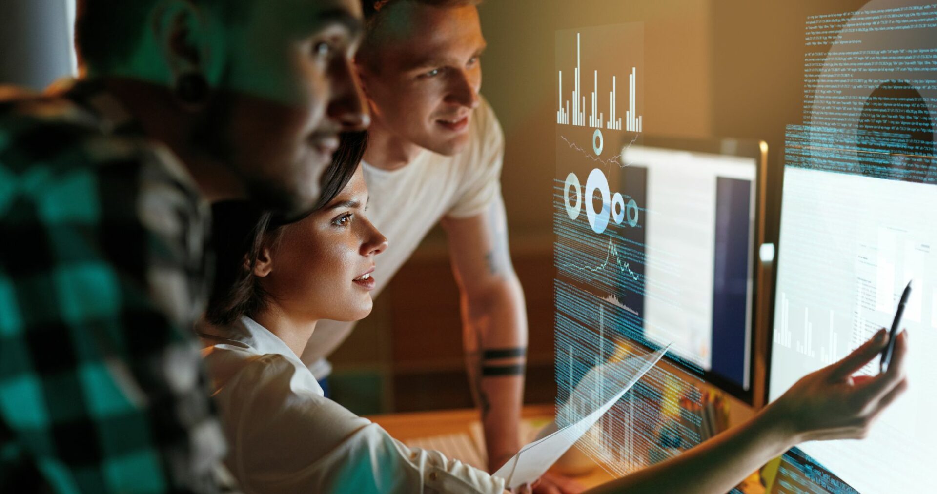 people crowding around a computer monitor to discuss