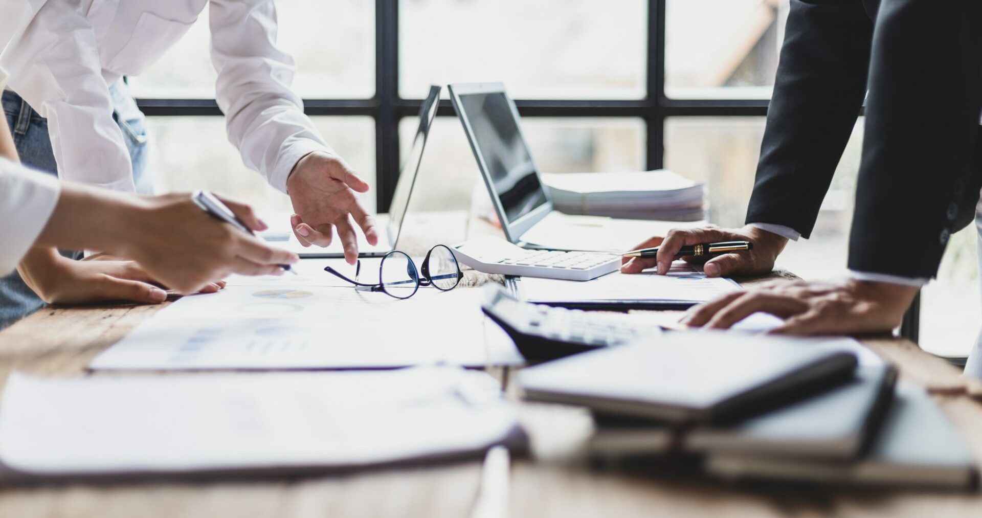 people working at a desk in an office